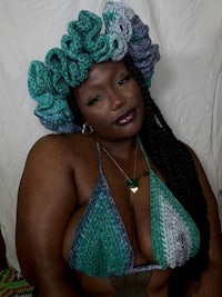 a black woman wearing a crocheted bikini