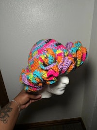 a mannequin wearing a colorful crocheted hat