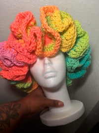 a mannequin wearing a colorful crocheted hat