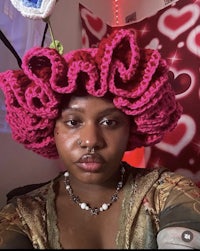 a woman wearing a pink crocheted hat