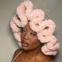 a woman wearing a pink fluffy hat