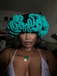a black woman wearing a crocheted hat
